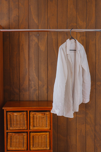 White shirt in brown wooden closet