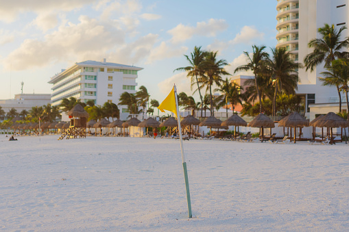 Scenic view of  yellow flag  on the beach in Hotel Zone in Cancun at sunset