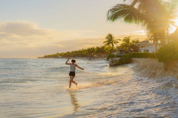 istock Woman running on the beach at sunset 1397026601