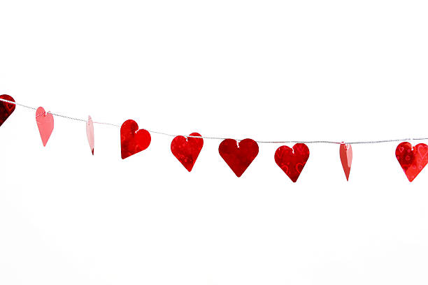istock Beautiful red hearts hanging on a line in white background 139702764