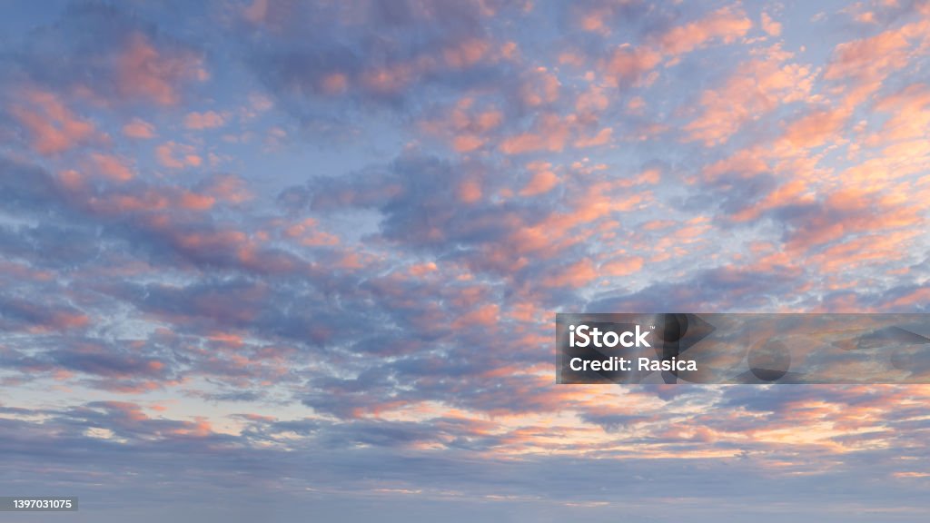 Pink blue sky with fluffy clouds at beautiful sunset as natural background. Atmospheric cloud great for nature desktop background use or sky replacement for real estate photography with the sunlight and abstract shape. Sky Stock Photo