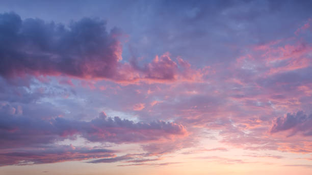 Pink sky with clouds at beautiful sunset as natural background. Atmospheric cloud great for nature desktop background use or sky replacement for real estate photography with the sunlight and abstract shape. sunset stock pictures, royalty-free photos & images