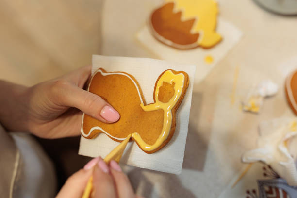 Preparation of gingerbread. The confectioner is painting gingerbread. Master class on gingerbread painting