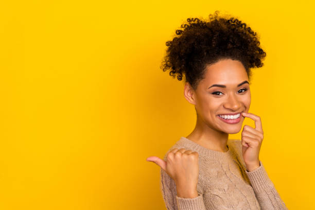 istock Photo of pretty tricky lady dressed beige pullover pointing empty space finger lips isolated yellow color background 1397033109