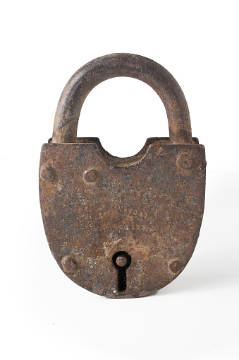 Old rusty metal lock on a white background