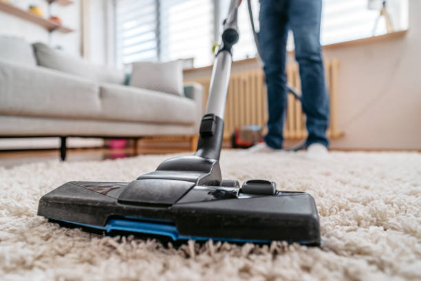 istock Young Man Vacuuming His Apartment 1397033965