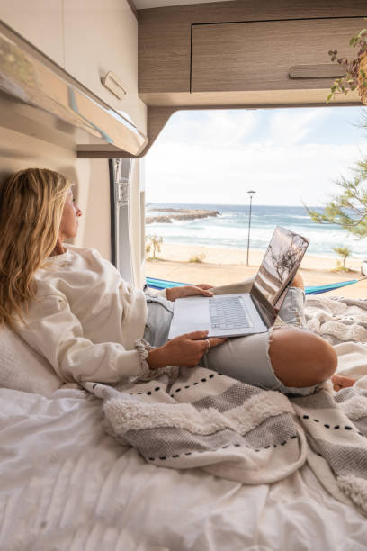 Woman working online from her Campervan stock photo