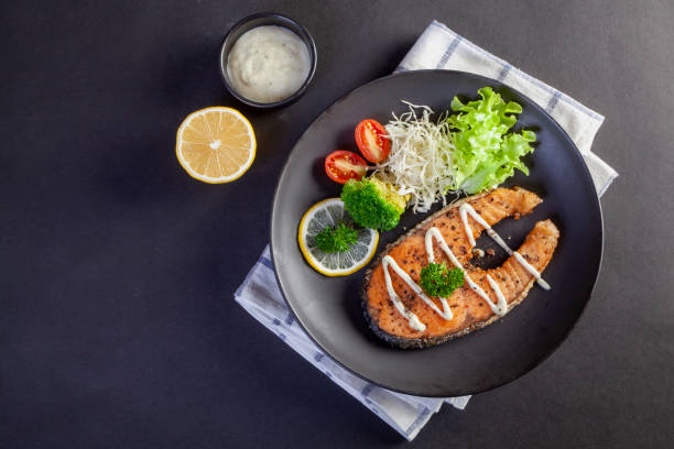 istock salmon steak on black background 1397034184