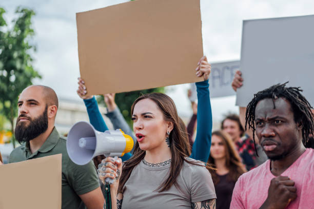 istock Group of people protesting in the street 1397034325