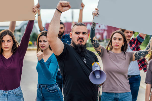 istock Group of people protesting in the street 1397034405