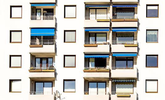 Traditional building facade with windows, jalousie, balconies in Austria, real estate concept