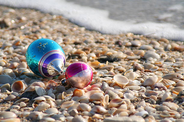 Seaside Christmas Ornaments on the seashore with shells and seafoam florida christmas stock pictures, royalty-free photos & images