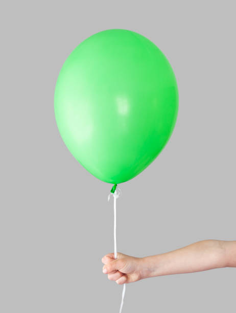 istock Green gel ball in hand on a gray background. 1397036346