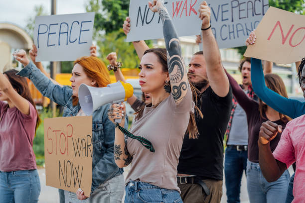 istock Group of people marching against war 1397036399