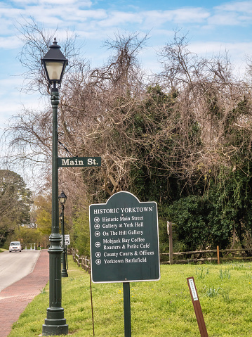 Yorktown, Virginia, USA - March 30, 2022: A sign along Main Street lists travel highlights in this historic town, site of a decisive siege and surrender during the American Revolutionary War (1775-1783).