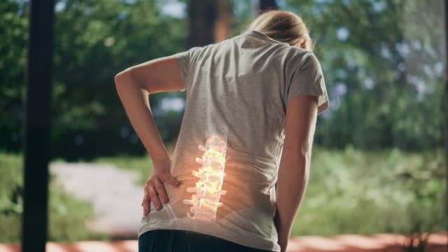 VFX Back Pain Augmented Reality Animation. Close Up of a Female Experiencing Discomfort in a Result of Spine Trauma or Arthritis. Massaging and Stretching the Back to Ease the Injury.