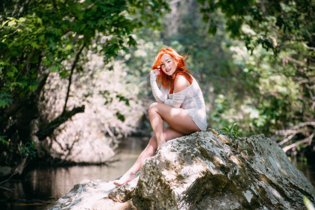 Beautiful Redhead Woman in the Untouched Forest and River
