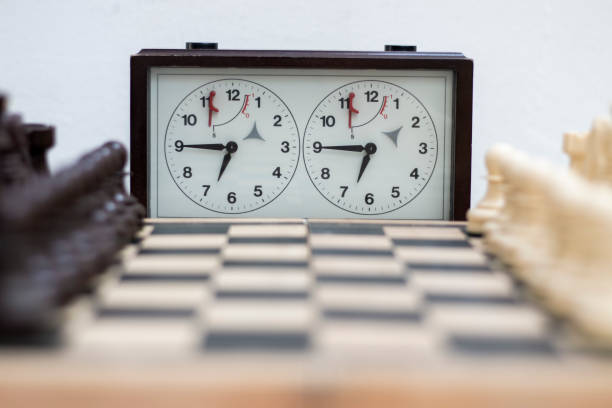 Chess Piece on Chessboard, Strategic Board Game of Leadersh Chess board with chess game being played against white background. Opening game board game piece stock pictures, royalty-free photos & images