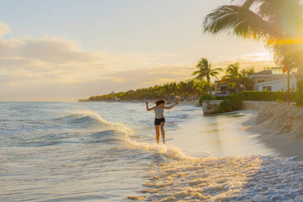 istock Woman running on the beach at sunset 1397040022