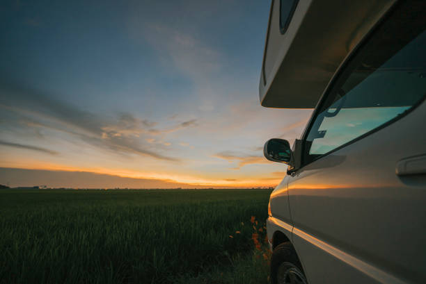 istock Motor home campervan park at rice paddy field during sunset 1397044797