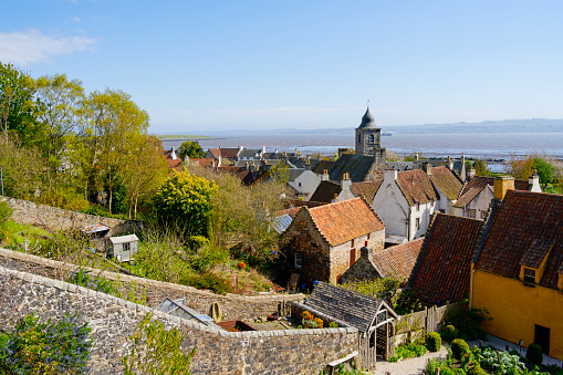 Over the rooftops of Culross village to the River Firth at low tide on a hazy afternoon.