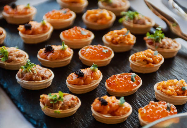 party snacks - canape appetizer gourmet salmon stock-fotos und bilder