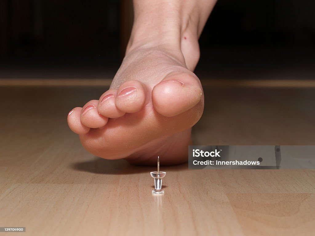 Standing on a pin_4 Woman about to stand on a pin Accidents and Disasters Stock Photo