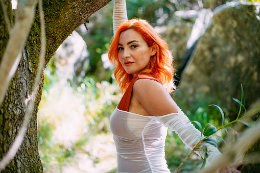 Beautiful Redhead Woman in the Untouched Forest and River