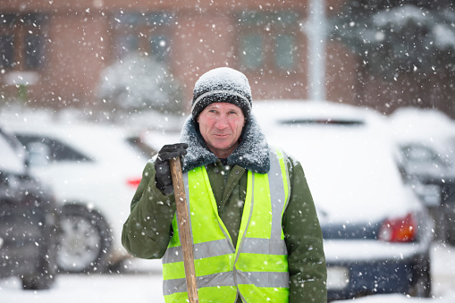 Portrait of a male janitor on a winter day.