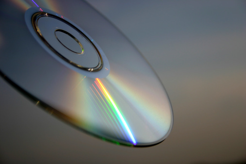 Compact disc close-up against the sky background.