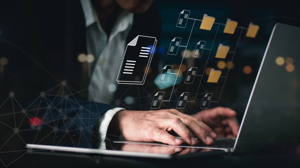 A guy using a Document Management System (DMS), an online documentation database, and process automation to handle files effectively, Corporate business technology. A guy using a Document Management System (DMS), an online documentation database, and process automation to handle files effectively, Corporate business technology. process automation office stock pictures, royalty-free photos & images