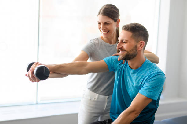 istock Modern rehabilitation physiotherapy woman worker with man client 1397054257