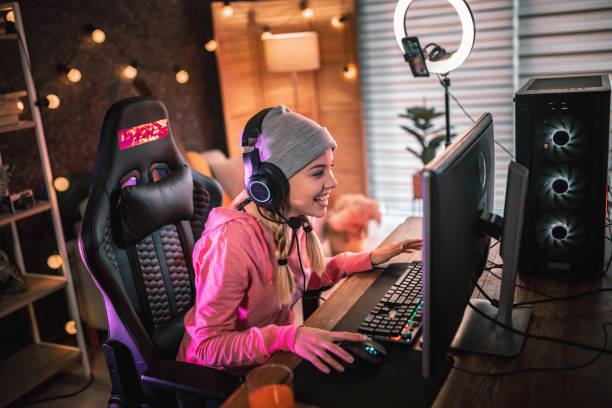 Girl plays video game online and streaming   at home Girl plays video game online and streaming   at home vlogging stock pictures, royalty-free photos & images