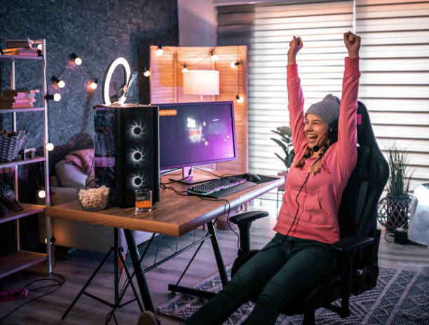 Girl plays video game online and streaming   at home stock photo