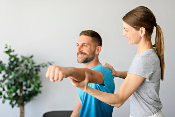 istock Modern rehabilitation physiotherapy woman worker with man client 1397055409