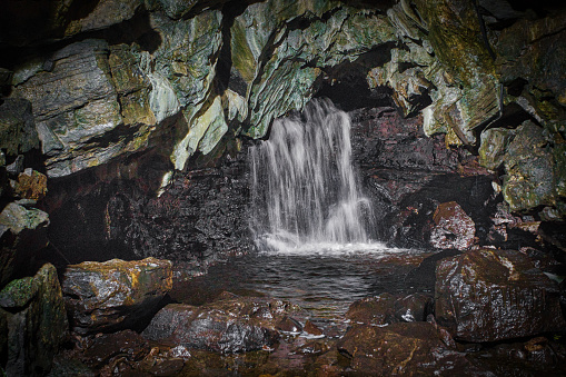 under ground waterfall at white scar caves in ingleton