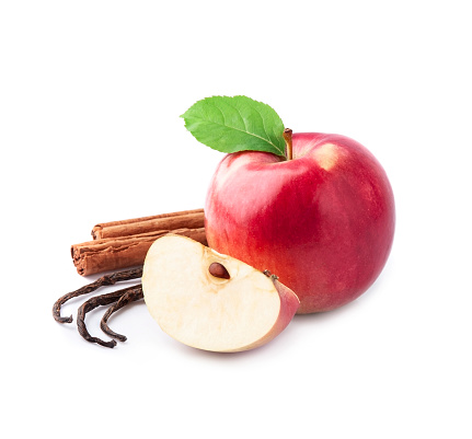 Red apples with cinnamon and vanilla stick on white backgrounds.
