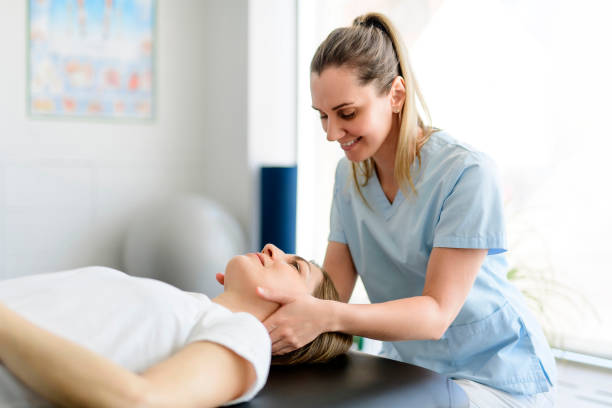 Modern rehabilitation physiotherapy woman worker with woman client stock photo