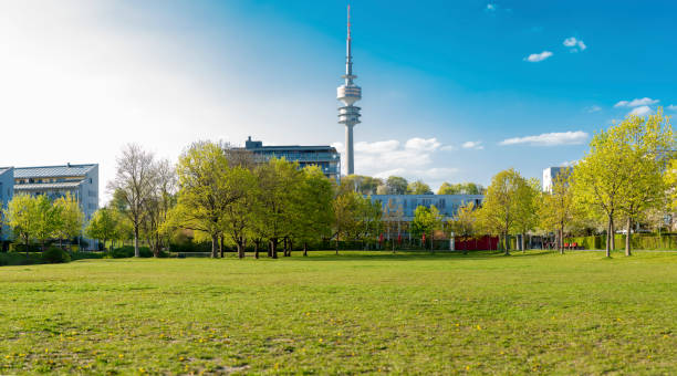 Large Meadow with Arabic Arc Park in Schwabing district in Munich looking north. Made in a panorama image.