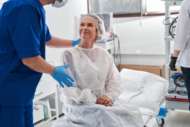 man calming his patient before the gastroscopy at the modern clinic - surgeon imagens e fotografias de stock