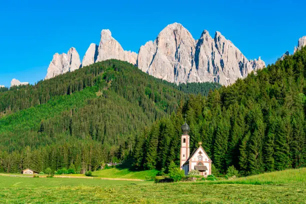 Church of St. John of Nepomuk in front of Odle mountain in Funes Valley of Dolomite South Tyrol Italy. View of San Giovanni Church or St. John's Church or St. Johann Churce in Val di Funes in small village of Ranui, Italy.