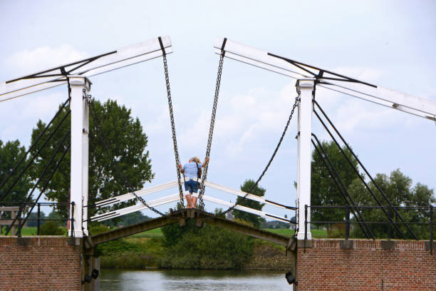 Heusen-Netherlands; 21 august 2021 : Two unrecognizable seniors take a selfie on a draw bridge of a fortified town Heusen. Romantic and an idyllic setting.