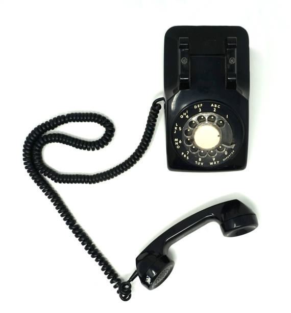 vecchio telefono rotante nero del gancio - obsolete landline phone old 1970s style foto e immagini stock