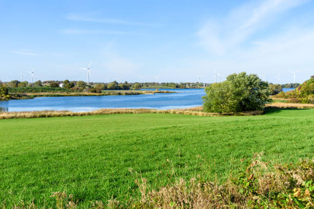 istock Wind farm along a river on a clear autumn day 1397060854