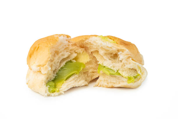 Freshly baked Pandan Custard Soft and fluffy bread,Pieces of bun stuffed with sweet Thai Pandan Custard on white background