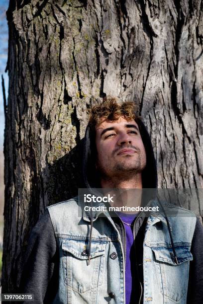 Portrait Of Young Man Leaning On A Tree Stock Photo - Download Image Now - Adult, Adults Only, Canada