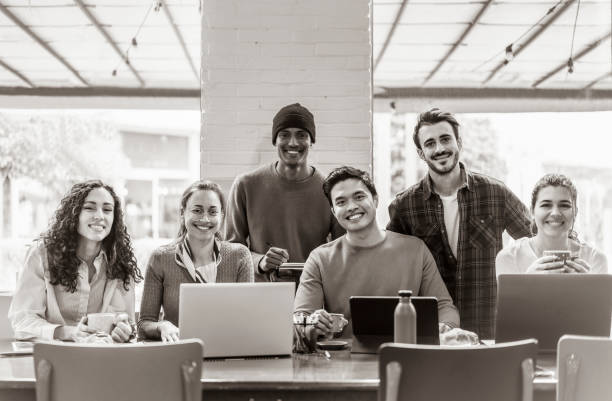 istock Smiling multiethnic coworkers looking at camera making team picture in modern office together - Happy diverse work group or department laugh posing for photo at workplace - Show unity and cooperation 1397062221