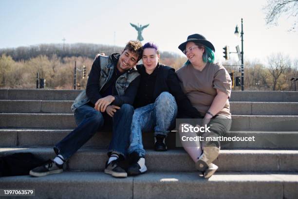 Group Of Lbgtqia Friends Enjoying Springtime In City Public Park Stock Photo - Download Image Now