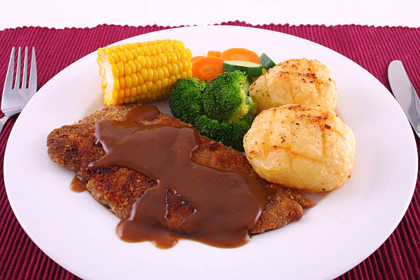 Crumbed steak dinner stock photo