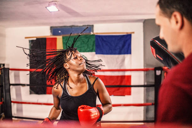 istock Female boxer training with her trainer in the ring 1397067604